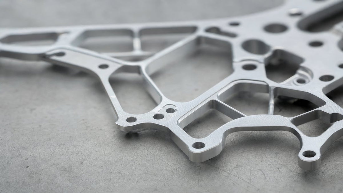 CNC machined thin-wall aluminum drone frame component on industrial workbench