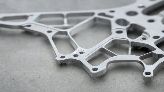 CNC machined thin-wall aluminum drone frame component on industrial workbench